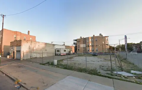 Fenced Corner Land with Car Wash Building