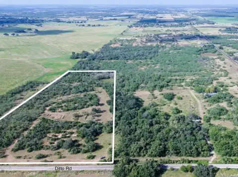 Tree-Covered Hunting Land with Pond