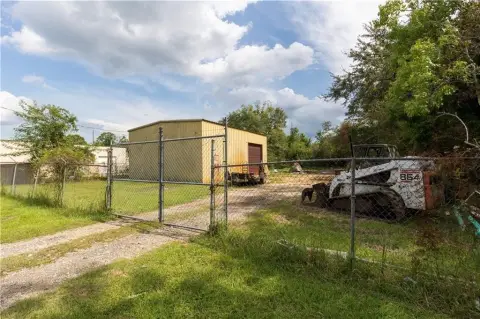 Fenced Warehouse with Roll-Up Door