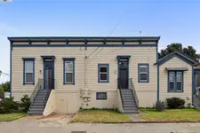 This brick two-unit multi-family property features two units, each with three bedrooms and one bathroom. The building includes a full basement and a two-car garage.