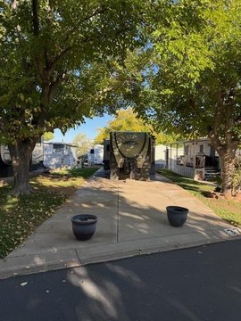 Shaded Lot with Coachman Trailer