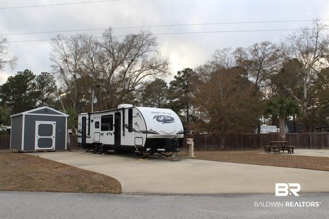 Shaded RV Resort Lot with Shed