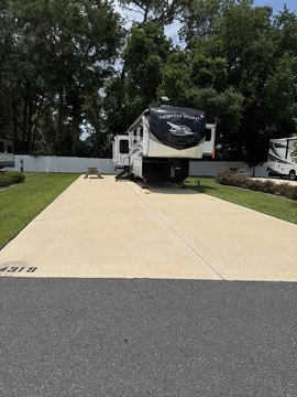 RV Resort Lot with Green Backdrop