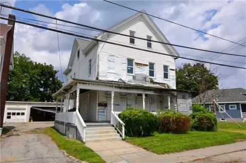Fire-Damaged Triplex with Garage