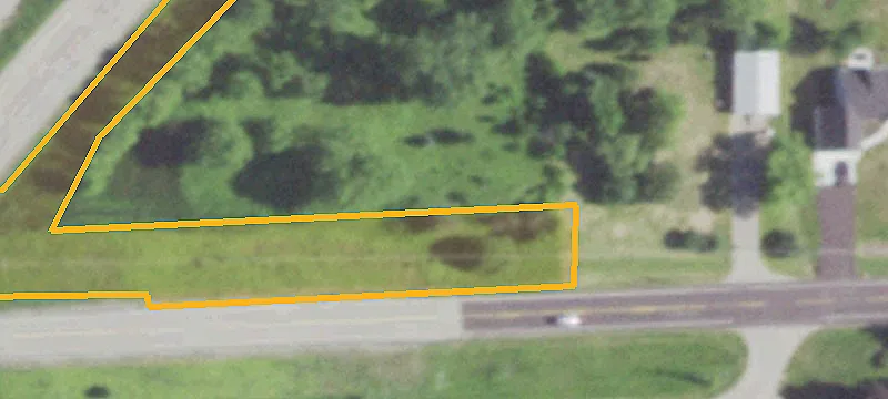 Vacant Lot with Garage and Driveway