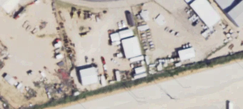 Fenced Industrial Yard with Shops