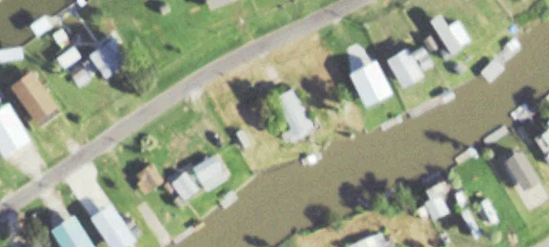 Fenced Waterfront Canal Lot with Dock