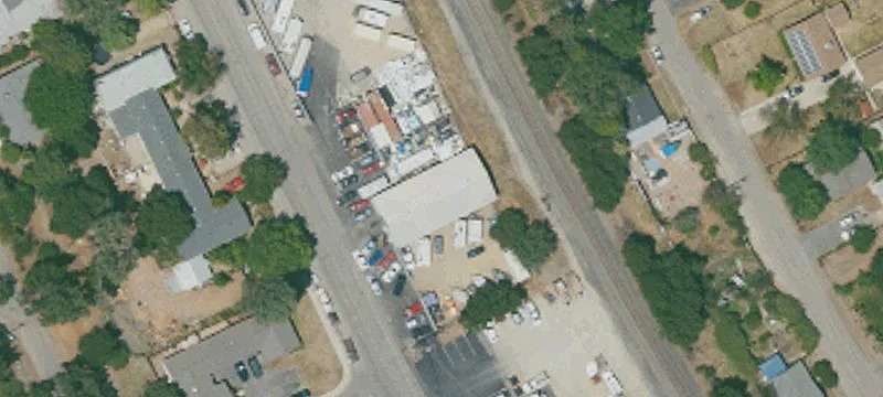 Fenced Industrial Yard with Warehouse