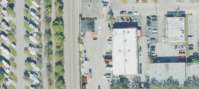 Fenced Industrial Yard with Warehouse
