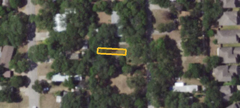 Undeveloped City Lot with Driveway Pad