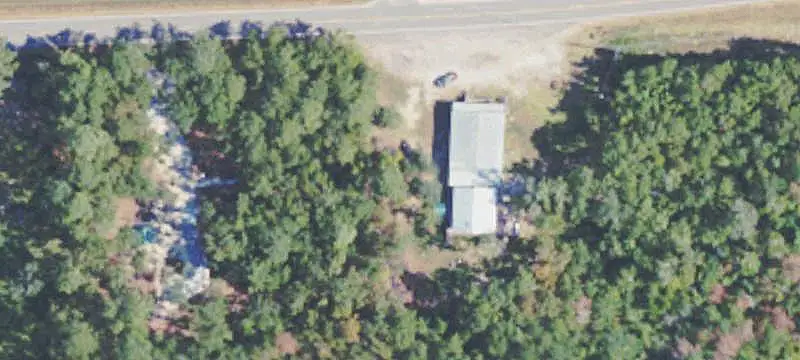 Partially Cleared Farmland with Storage