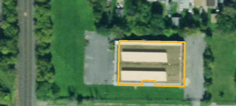 Warehouse with Cranes and Fenced Yard